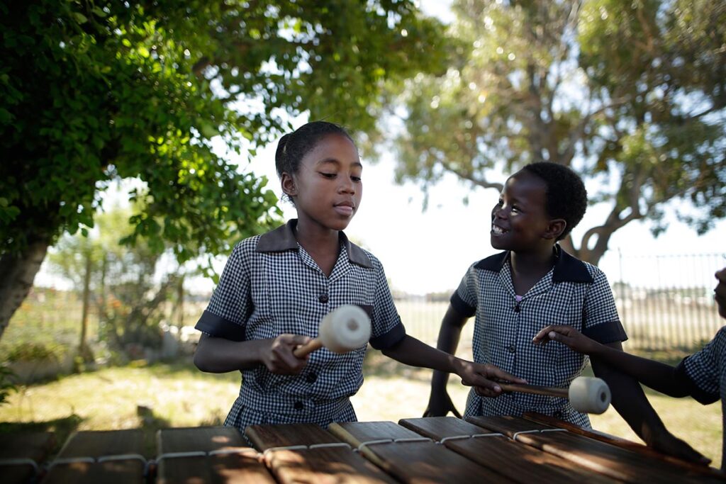 A PFCF student playing marimba